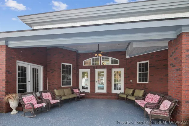 a front view of a house with swimming pool having outdoor seating