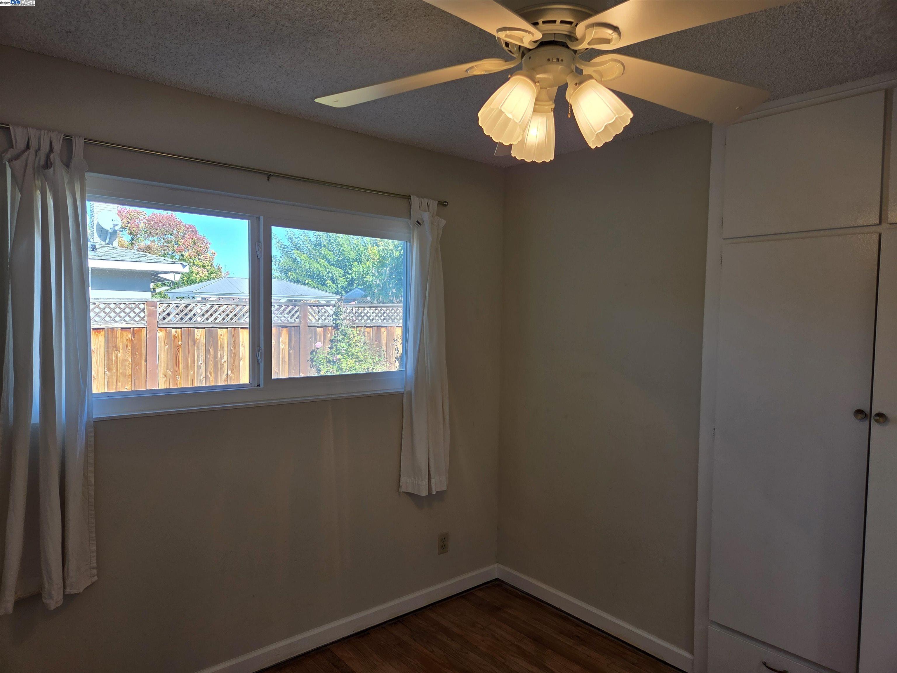 6198 Hancock Avenue San Jose, CA 95123 - Photo 11 of 27 a view of an empty room with wooden floor and a window