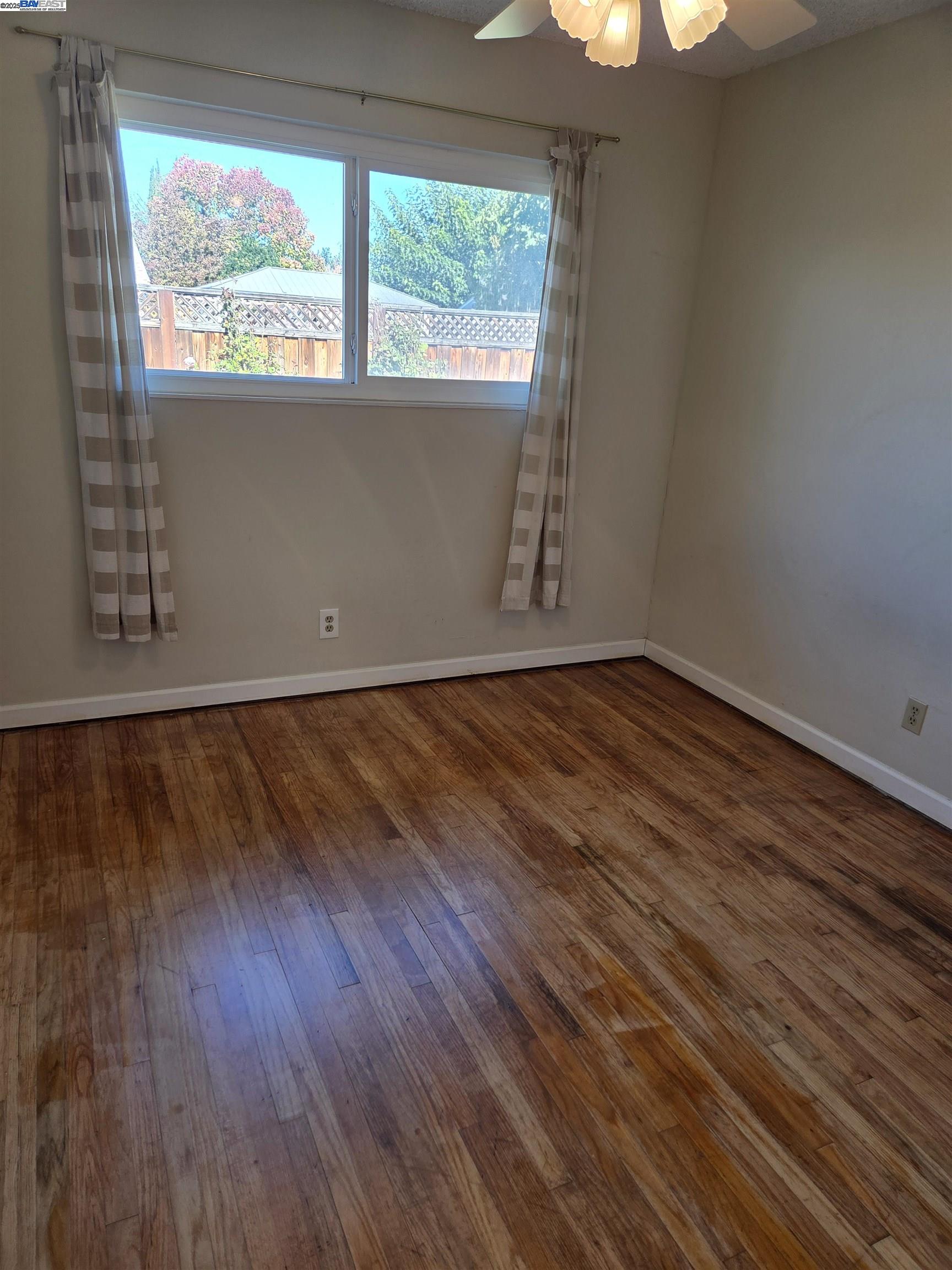 6198 Hancock Avenue San Jose, CA 95123 - Photo 12 of 27 a view of an empty room with wooden floor and a window