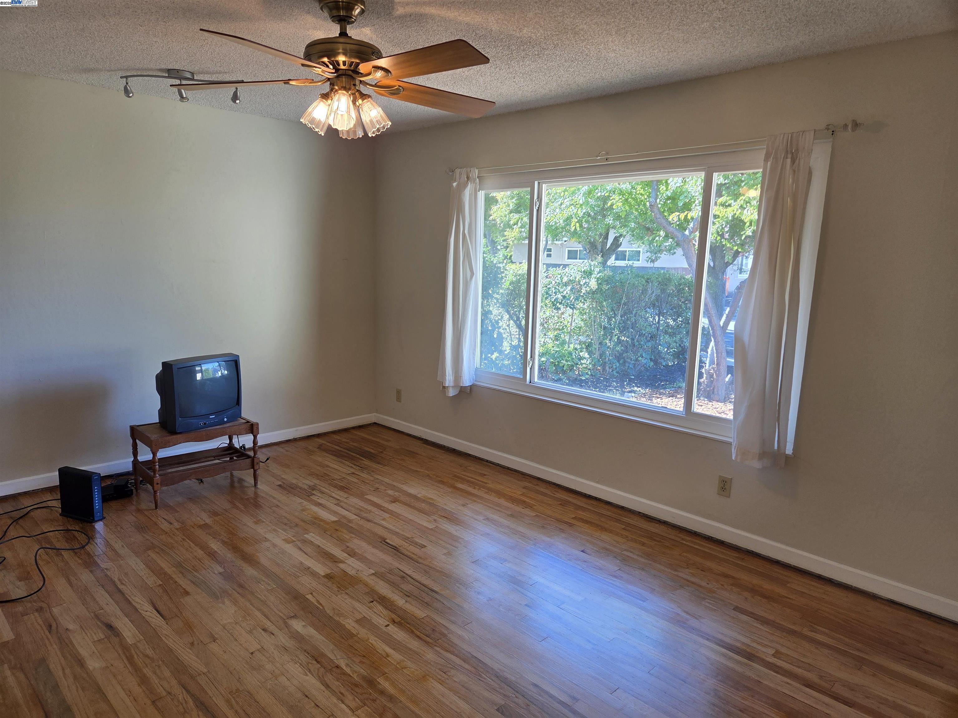 6198 Hancock Avenue San Jose, CA 95123 - Photo 2 of 27 a view of room with window ceiling fan and hardwood floor