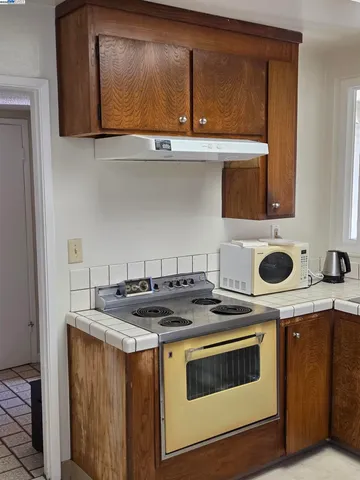 a kitchen with a stove and a microwave