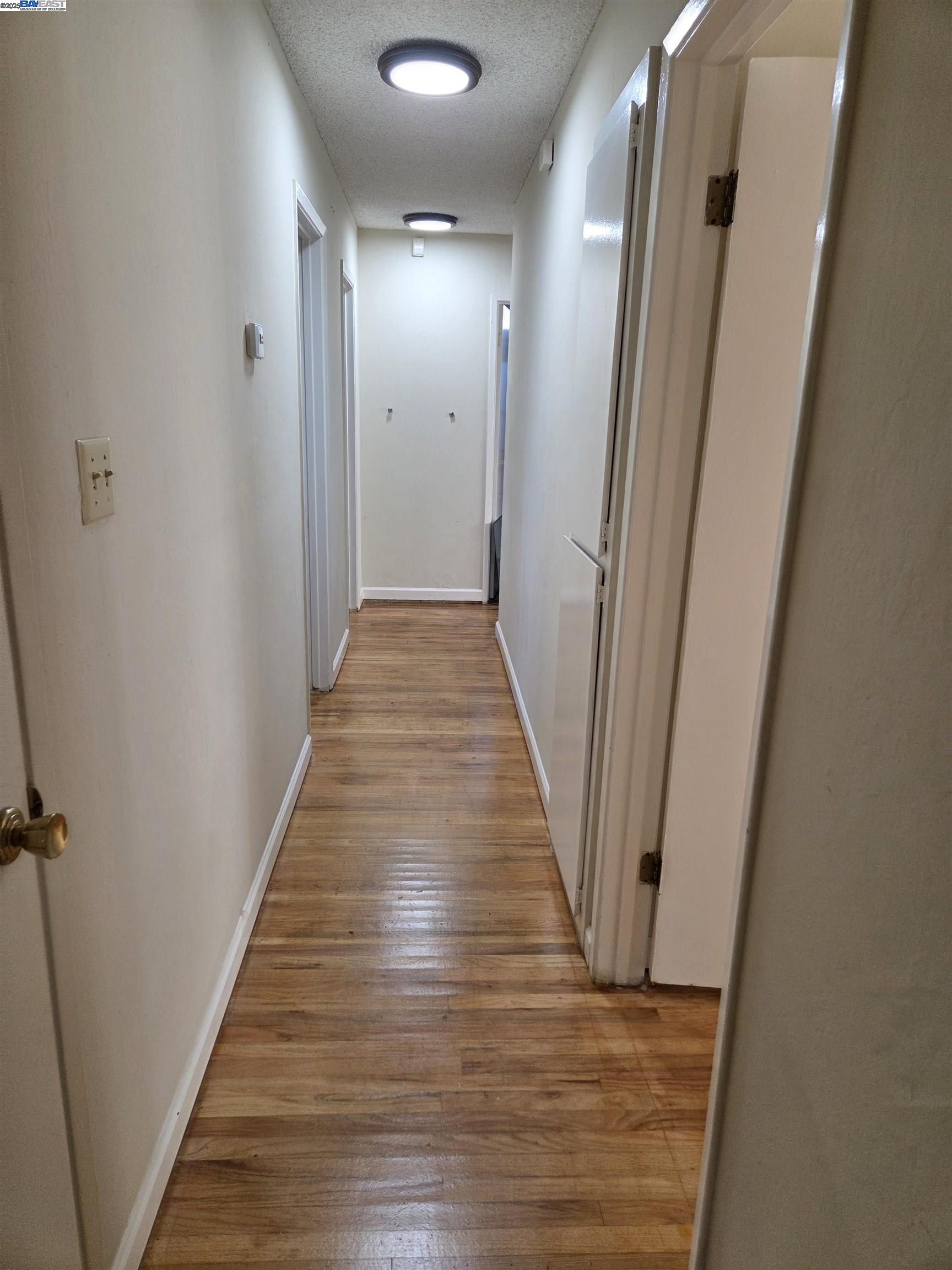 6198 Hancock Avenue San Jose, CA 95123 - Photo 7 of 27 a view of a hallway with wooden floor and staircase
