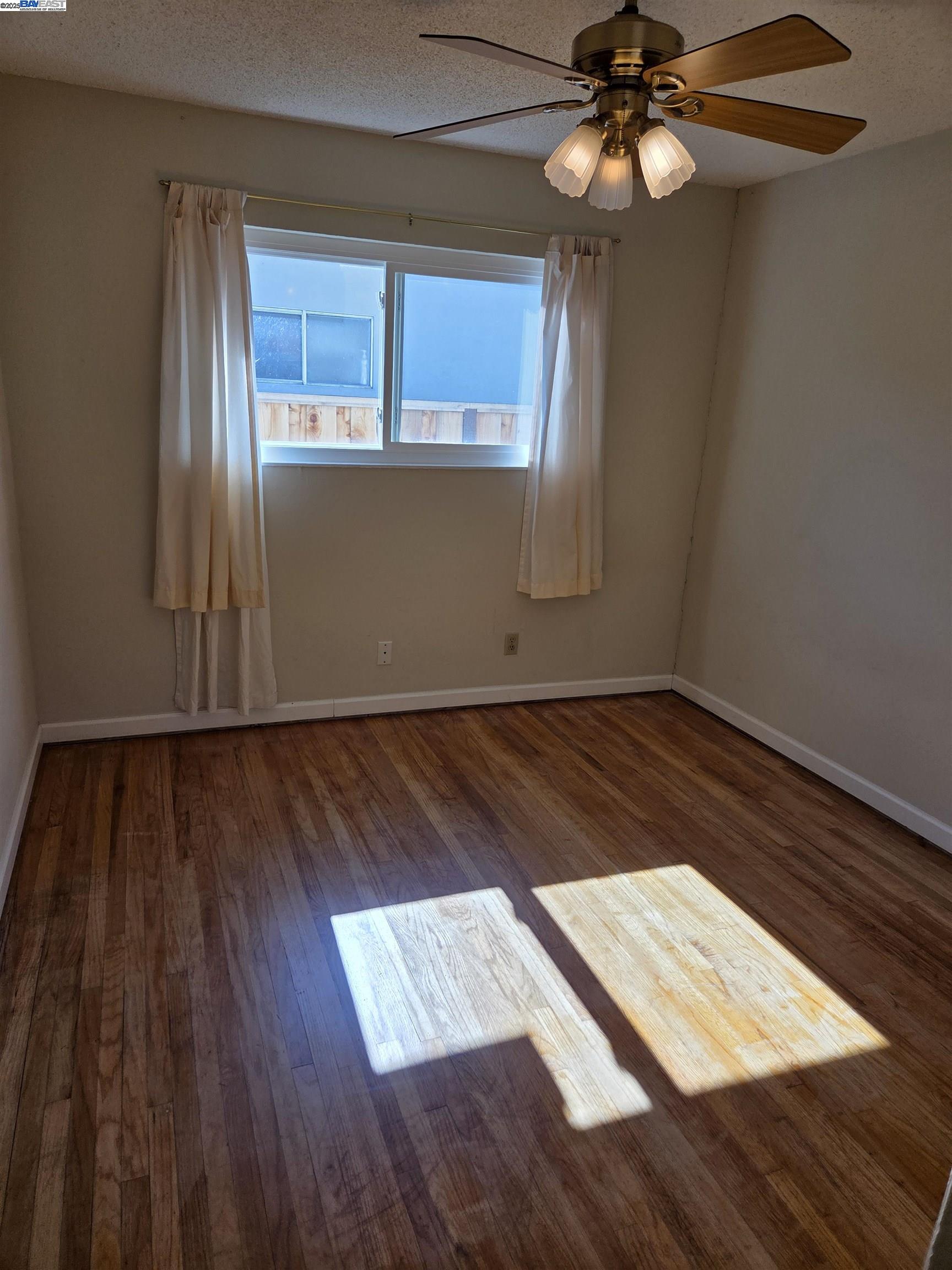 6198 Hancock Avenue San Jose, CA 95123 - Photo 8 of 27 a view of an empty room window and wooden floor
