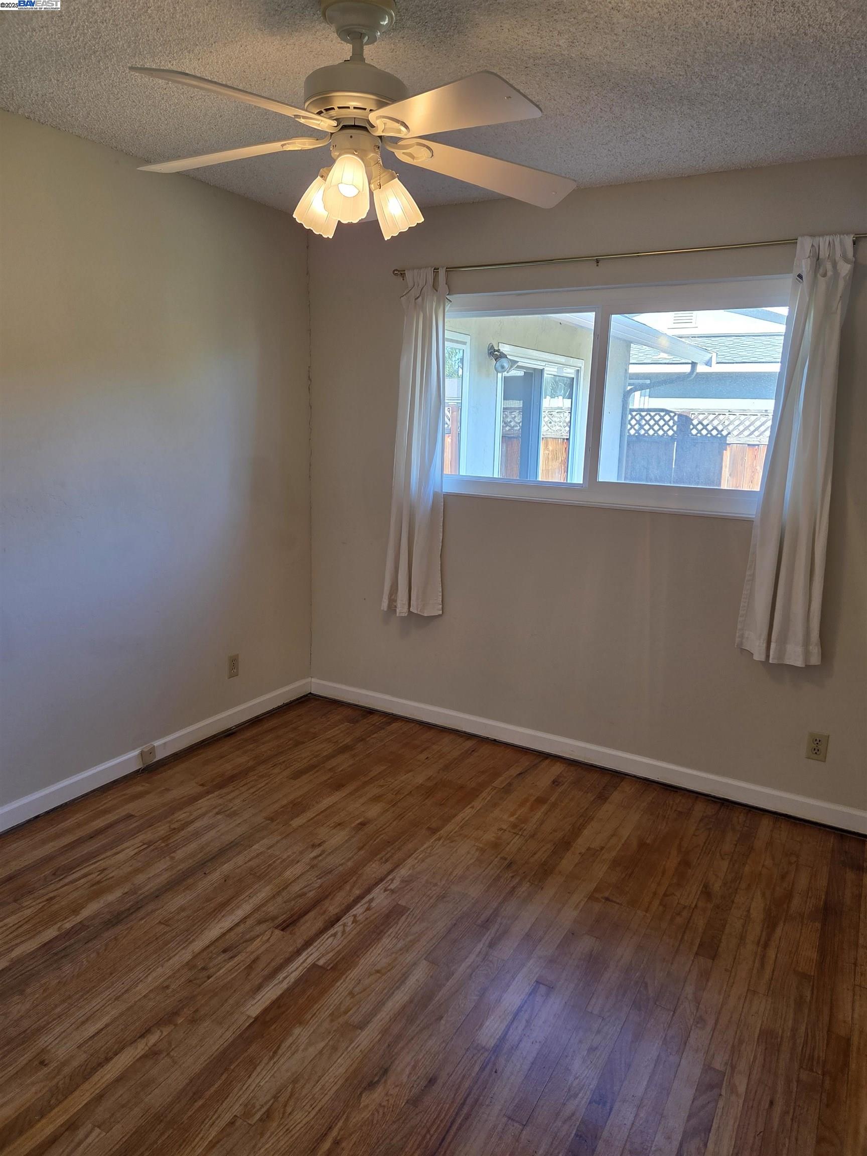 6198 Hancock Avenue San Jose, CA 95123 - Photo 10 of 27 a view of an empty room with wooden floor and fan