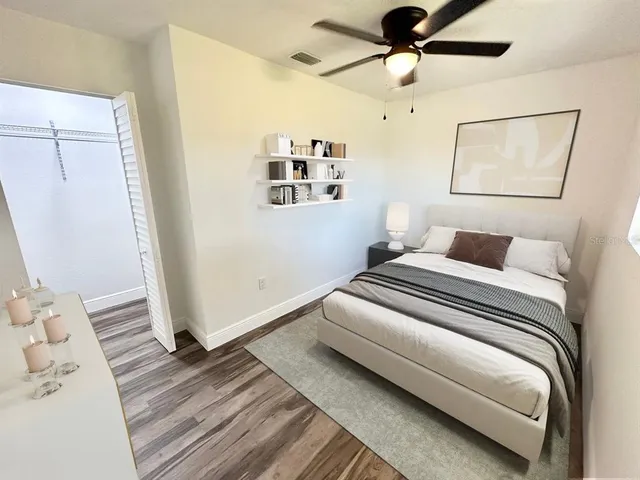 a bedroom with a bed and wooden floor