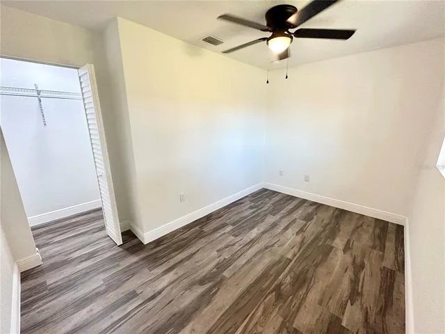a view of a room with wooden floor