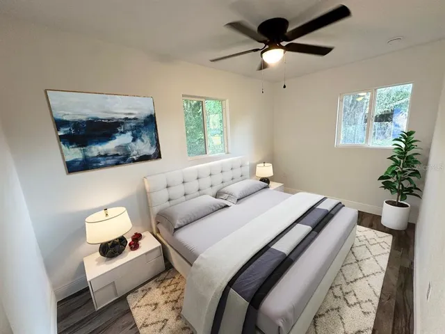 a bedroom with a bed and a painting on the wall