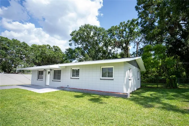 a backyard of a house with yard and trampoline