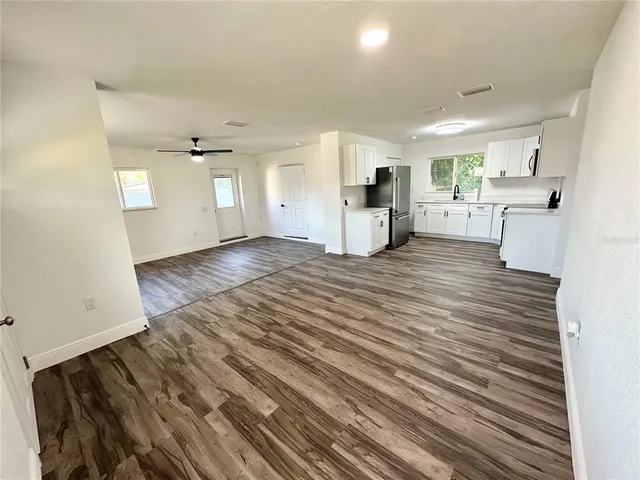 a view of a living room with hardwood floor