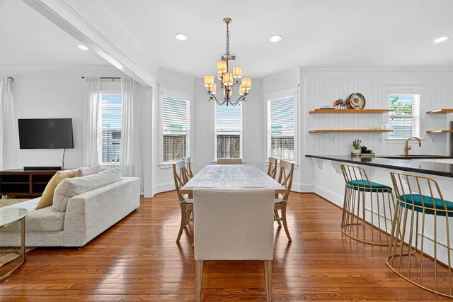 a view of a dining room with furniture wooden floor and chandelier