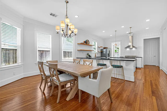 a kitchen with stainless steel appliances granite countertop a stove and a wooden floors