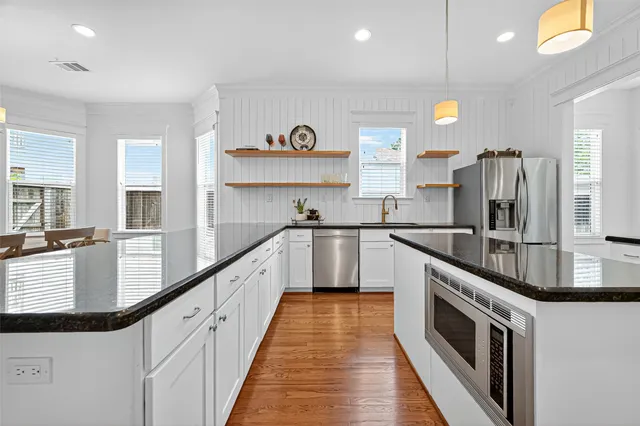 a kitchen with refrigerator and window