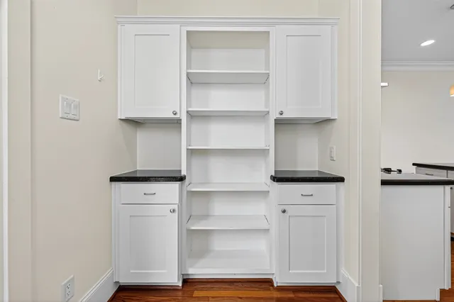 a bedroom with a bed chandelier and a window