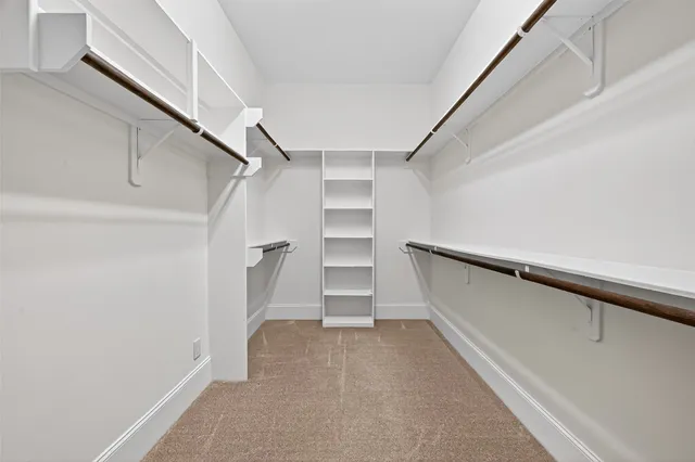 a bathroom with a granite countertop sink a mirror and a bathtub