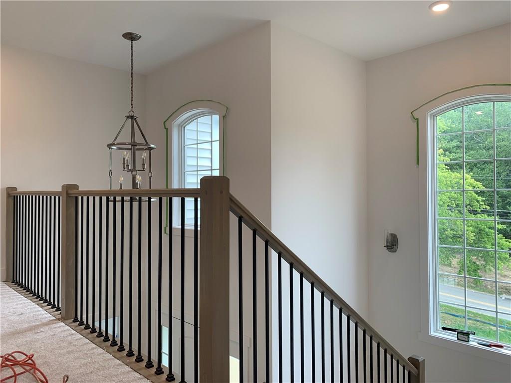 295 Hutchman Road Mars, PA 16046 - Photo 18 of 25 Two story entry has fully stained wood steps (partially covered with paper) and black iron spindles