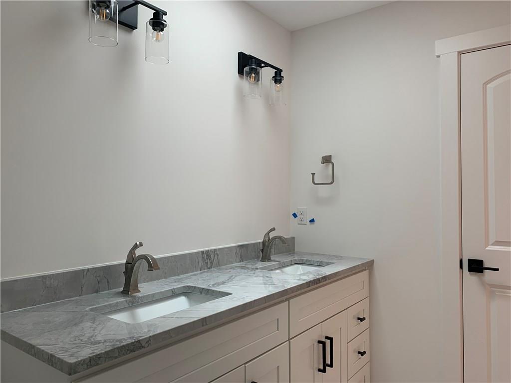 295 Hutchman Road Mars, PA 16046 - Photo 19 of 25 Double vanity for second floor bathroom! Timeless finishes - light grey ceramic floors, white cabinet and modern black hardware. Skylight above vanity gives this bathroom great natural light!