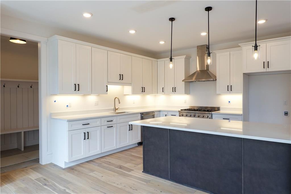 295 Hutchman Road Mars, PA 16046 - Photo 9 of 25 Kitchen cabinets are installed! We went for light and bright with contrasting black hardware! Stained island to add some warmth, stainless steel appliances and white quartz counter tops with a light grey vein. will make for a stunning kitchen!