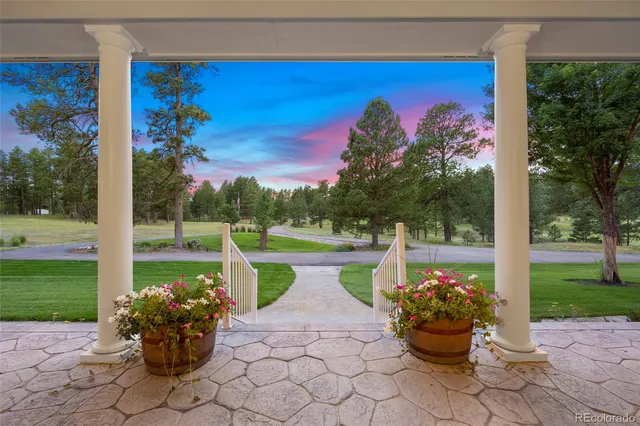 a living room with furniture a fireplace and a large window