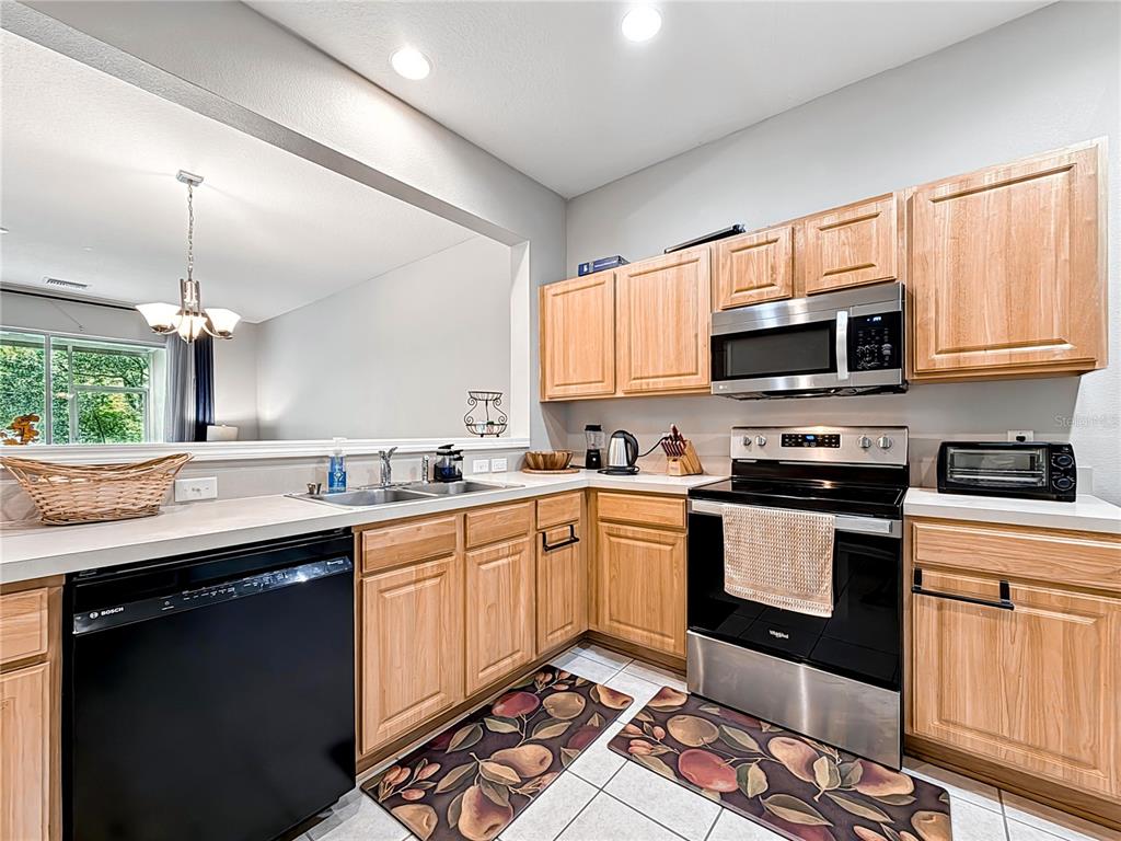 2617 Redford Way Wesley Chapel, FL 33544 - Photo 11 of 21 a kitchen with stainless steel appliances granite countertop a sink a stove a microwave and cabinets