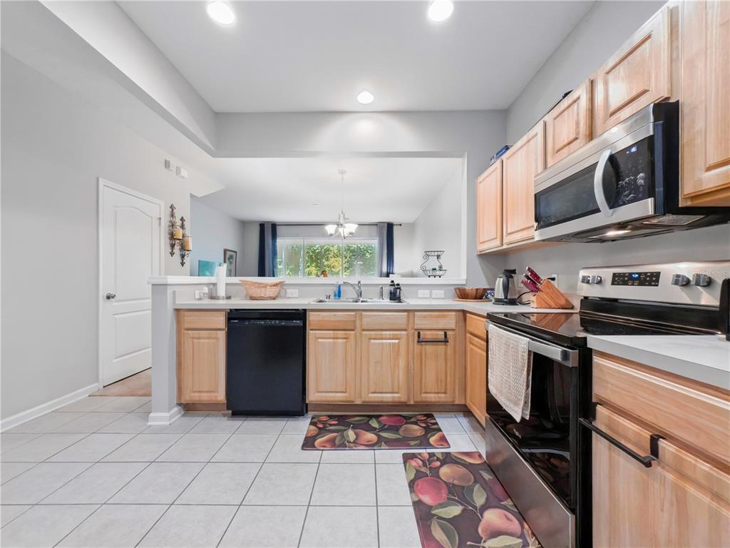 2617 Redford Way Wesley Chapel, FL 33544 - Photo 13 of 21 a kitchen with stainless steel appliances granite countertop a stove a sink and a microwave
