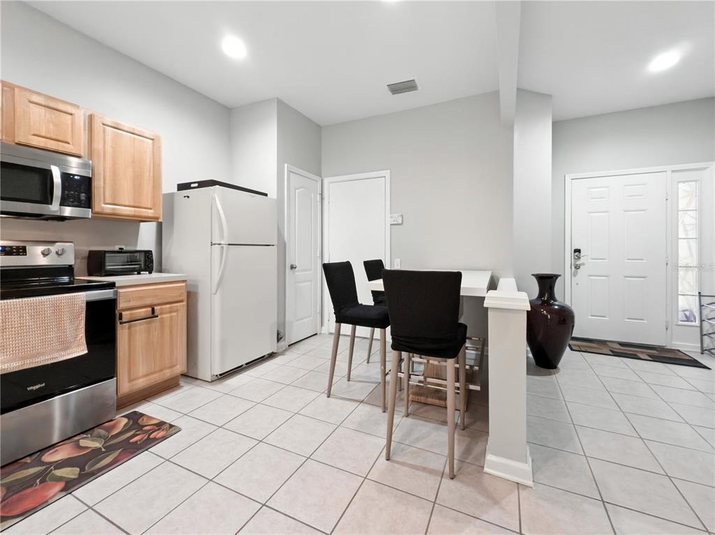 2617 Redford Way Wesley Chapel, FL 33544 - Photo 14 of 21 a kitchen with stainless steel appliances kitchen island granite countertop a refrigerator and a stove top oven