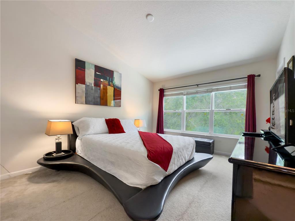 2617 Redford Way Wesley Chapel, FL 33544 - Photo 7 of 21 a bedroom with a bed and a large window