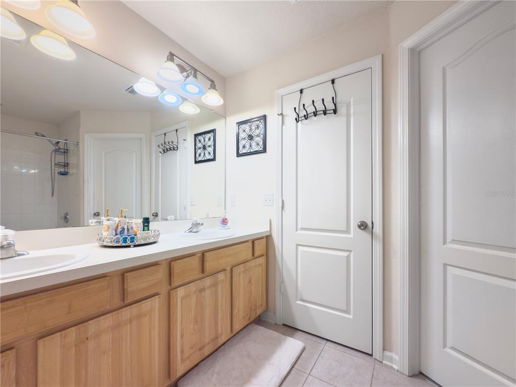2617 Redford Way Wesley Chapel, FL 33544 - Photo 8 of 21 a bathroom with a double vanity sink and mirror