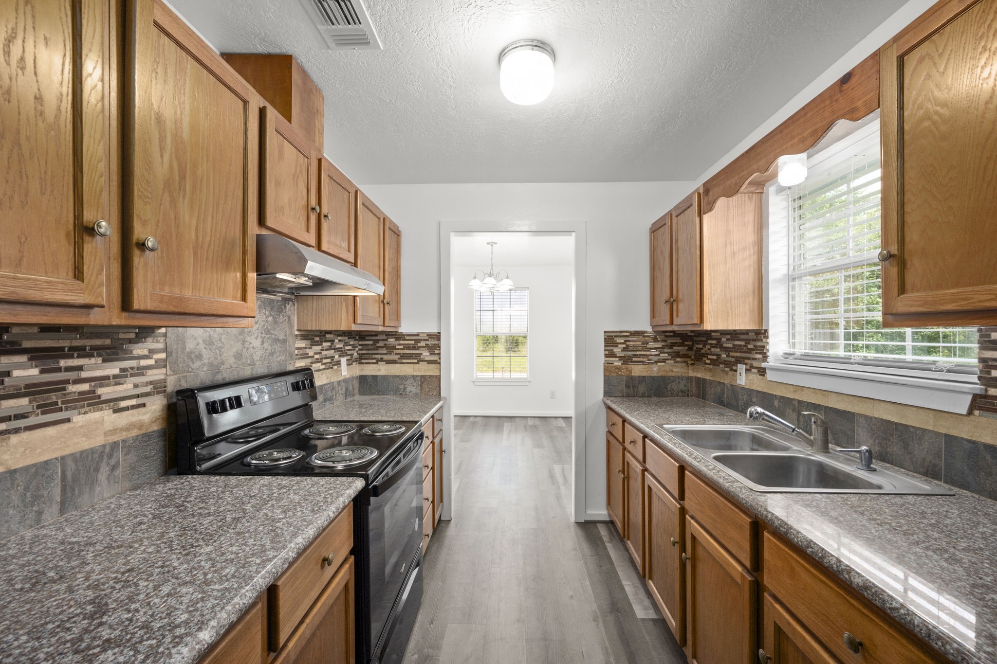 1935 1st Street Hempstead, TX 77445 - Photo 19 of 29 a kitchen with stainless steel appliances granite countertop a stove a sink and a microwave