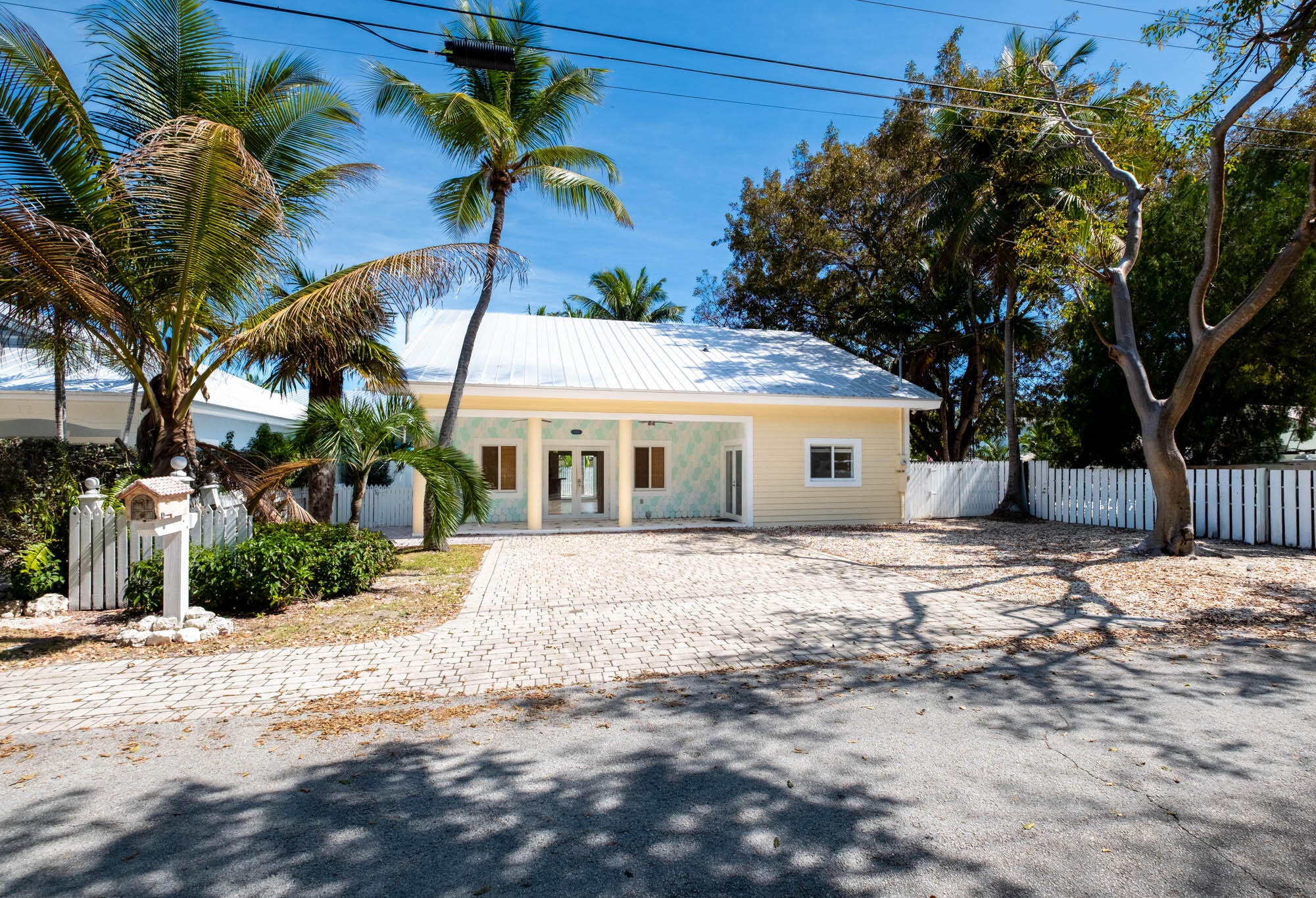 118 1st Street Key Largo, FL 33037 - Photo 1 of 25 a front view of house with a garden