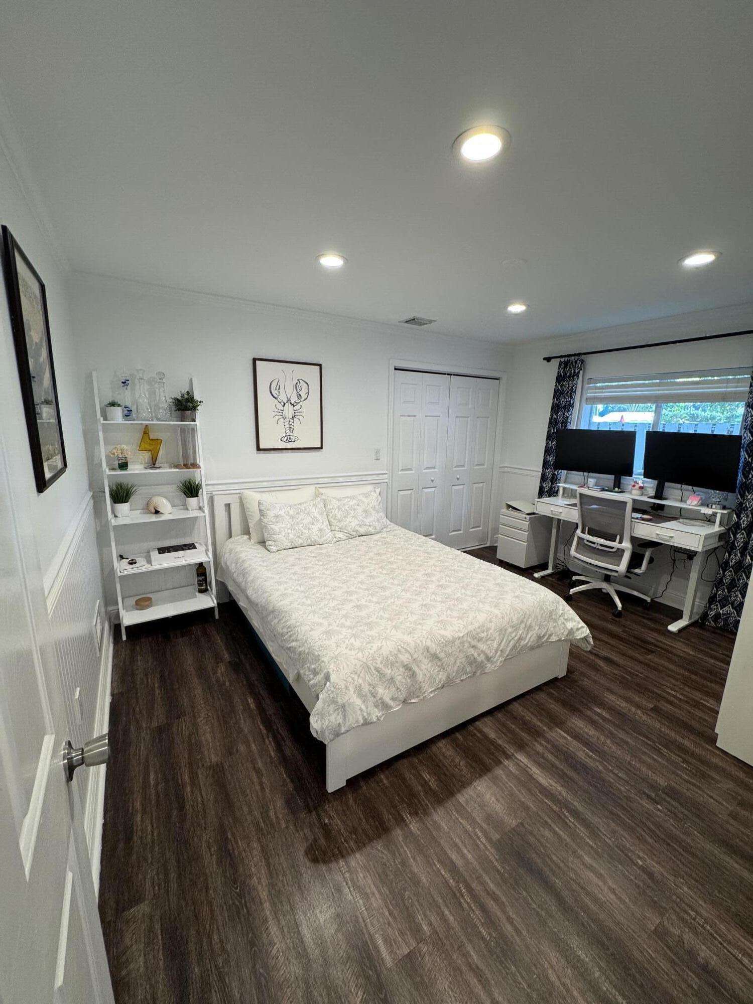 118 1st Street Key Largo, FL 33037 - Photo 5 of 10 a spacious bedroom with a bed and a view of kitchen