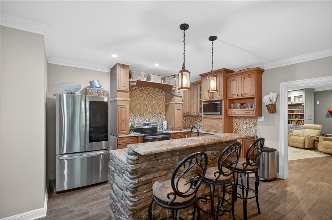 206 James Hare Road Anderson, SC 29626 - Photo 16 of 37 A gourmet kitchen awaits with premium appliances and a natural stone-clad breakfast bar.