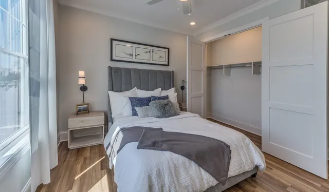 a bedroom with a bed and painting on the wall