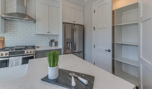 a kitchen with a refrigerator and a stove