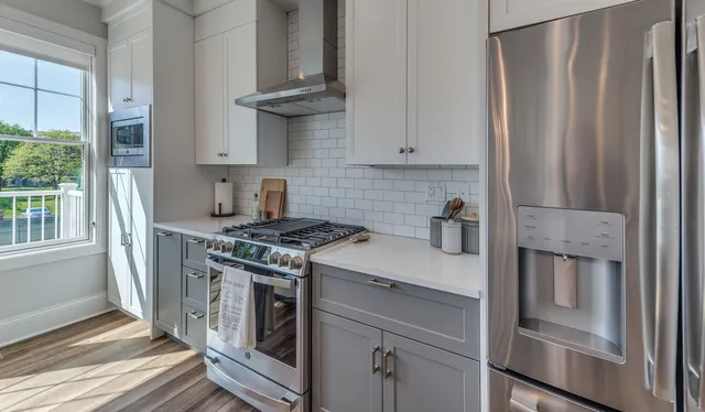 a kitchen with stainless steel appliances granite countertop a stove and a refrigerator