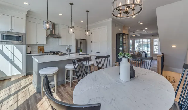 a kitchen with a table chairs and a dining table