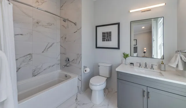 a bathroom with a sink toilet and shower