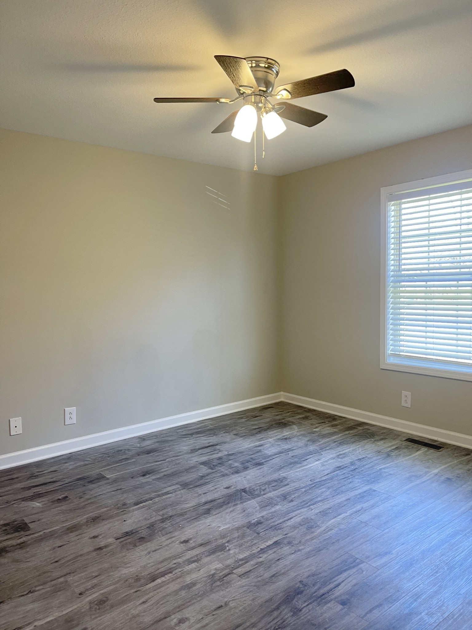 1845 Hugh Hunter Road Oak Grove, KY 42262 - Photo 6 of 6 a view of an empty room with wooden floor and a window