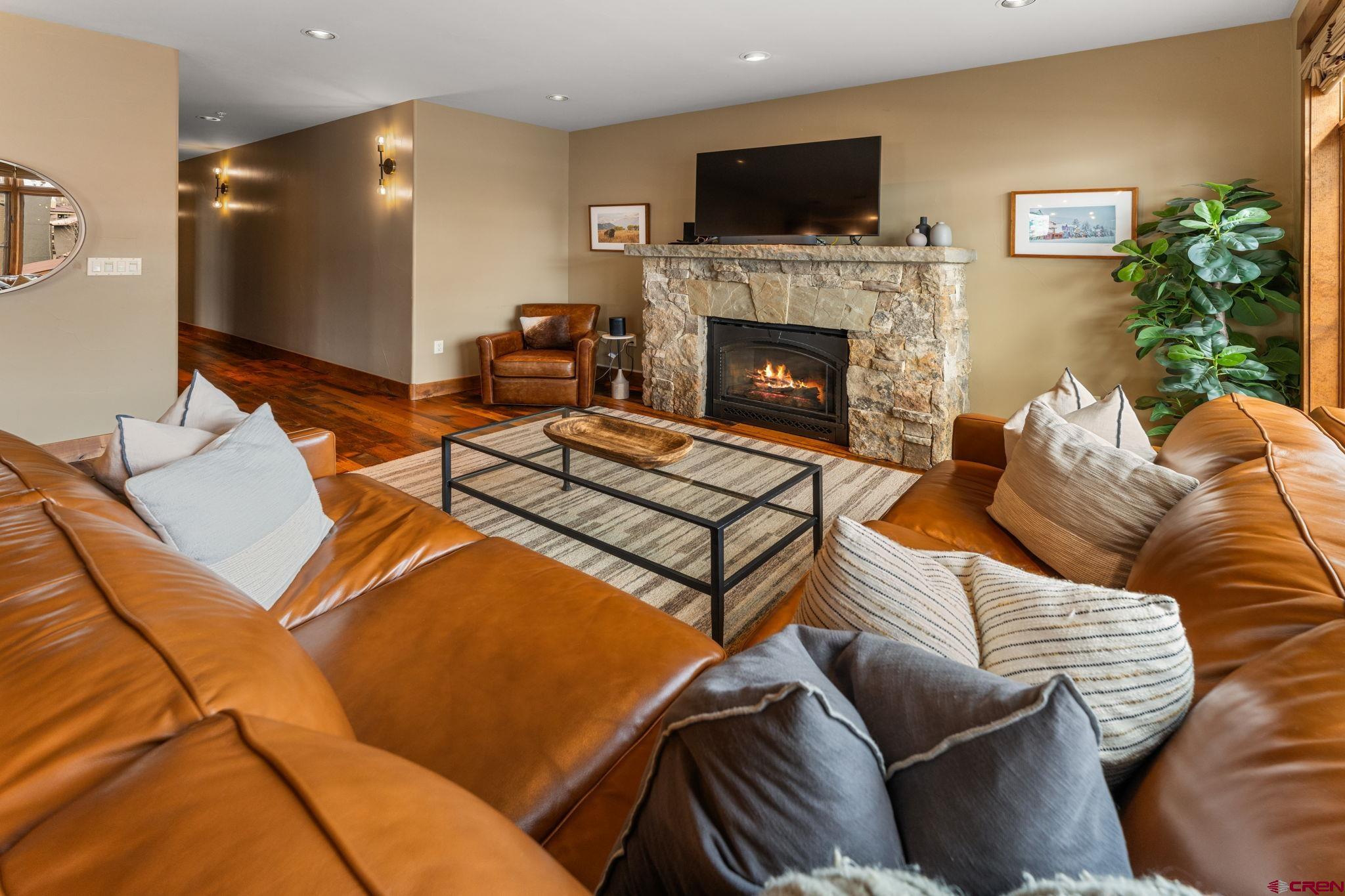 621 Gothic Road, Unit 2A Crested Butte, CO 81225 - Photo 13 of 34 a living room with furniture a flat screen tv and a fireplace