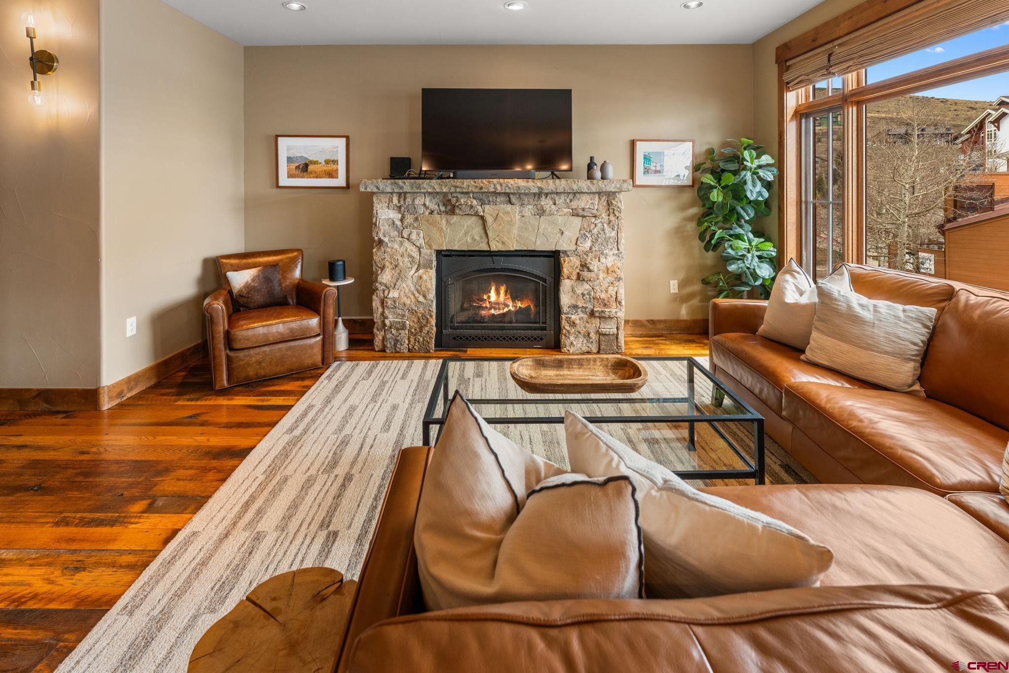 621 Gothic Road, Unit 2A Crested Butte, CO 81225 - Photo 14 of 34 a living room with furniture and a fireplace