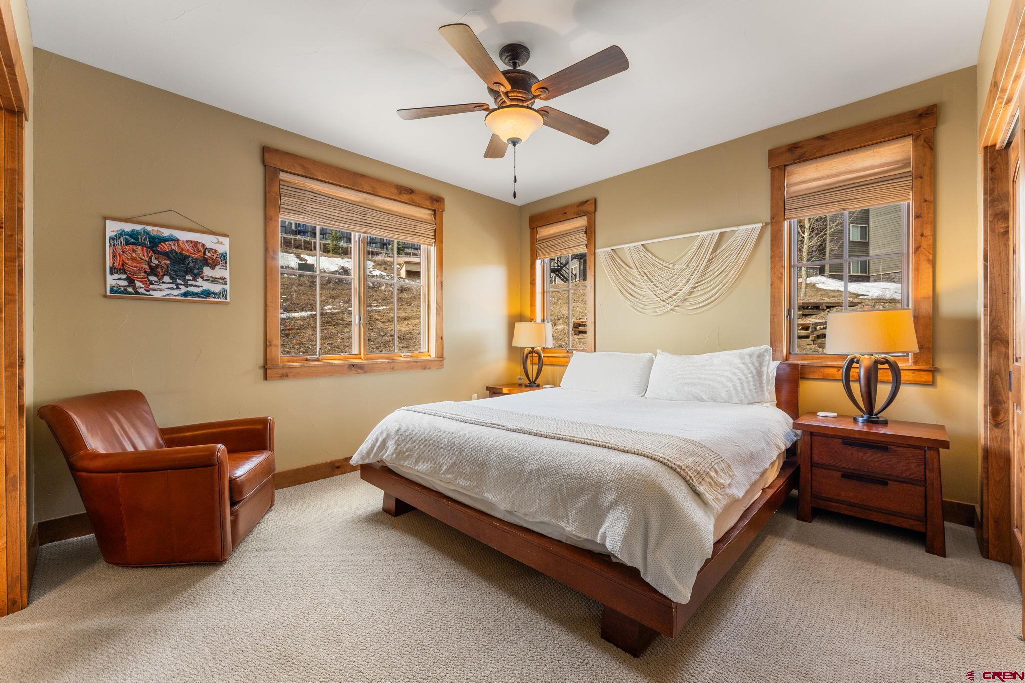 621 Gothic Road, Unit 2A Crested Butte, CO 81225 - Photo 16 of 34 a bedroom with a bed couch and window