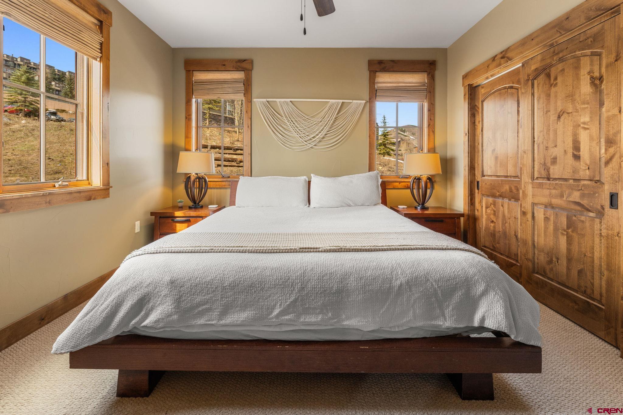 621 Gothic Road, Unit 2A Crested Butte, CO 81225 - Photo 17 of 34 a bedroom with a bed and wooden floor