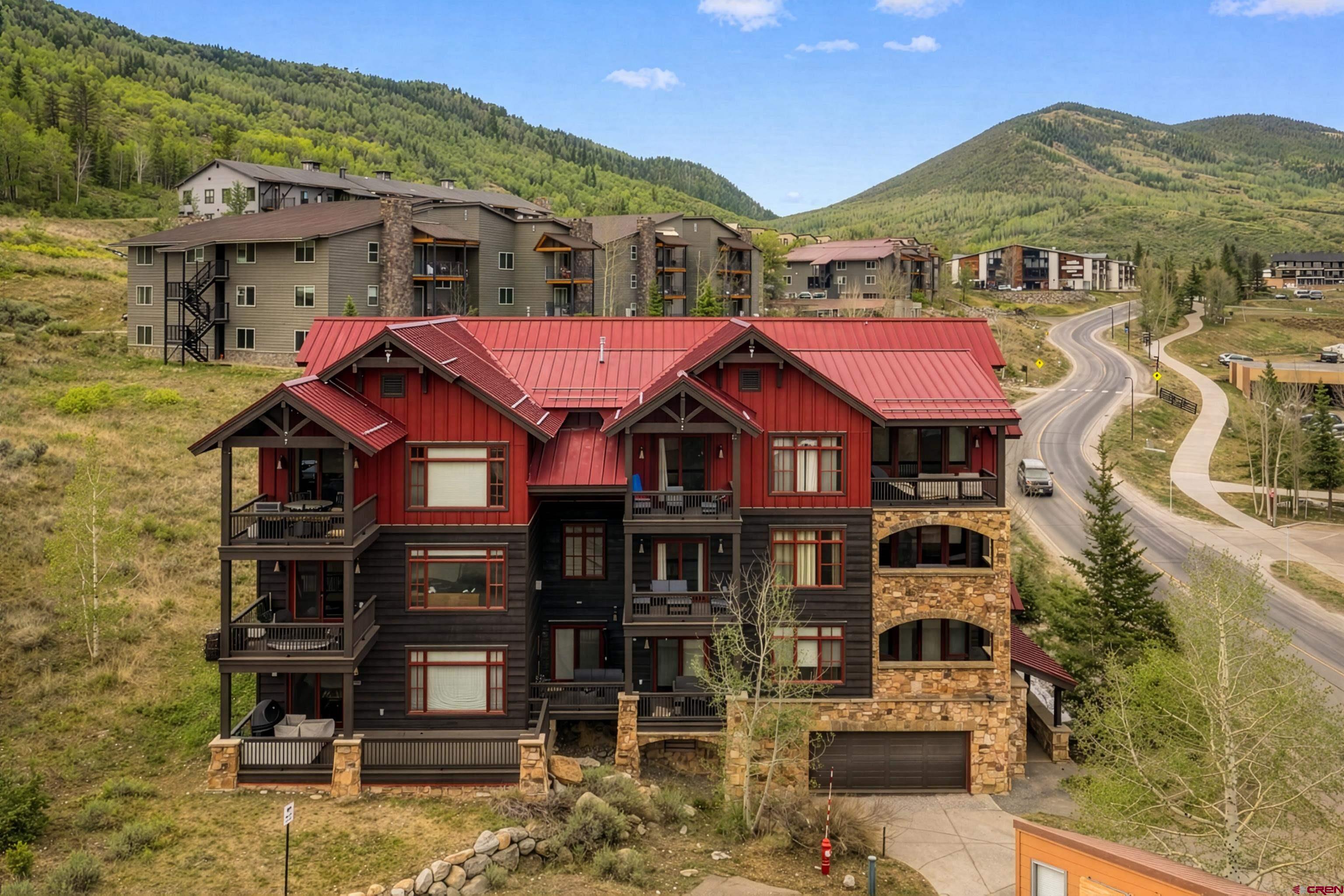 621 Gothic Road, Unit 2A Crested Butte, CO 81225 - Photo 2 of 34 a front view of a houses with a yard