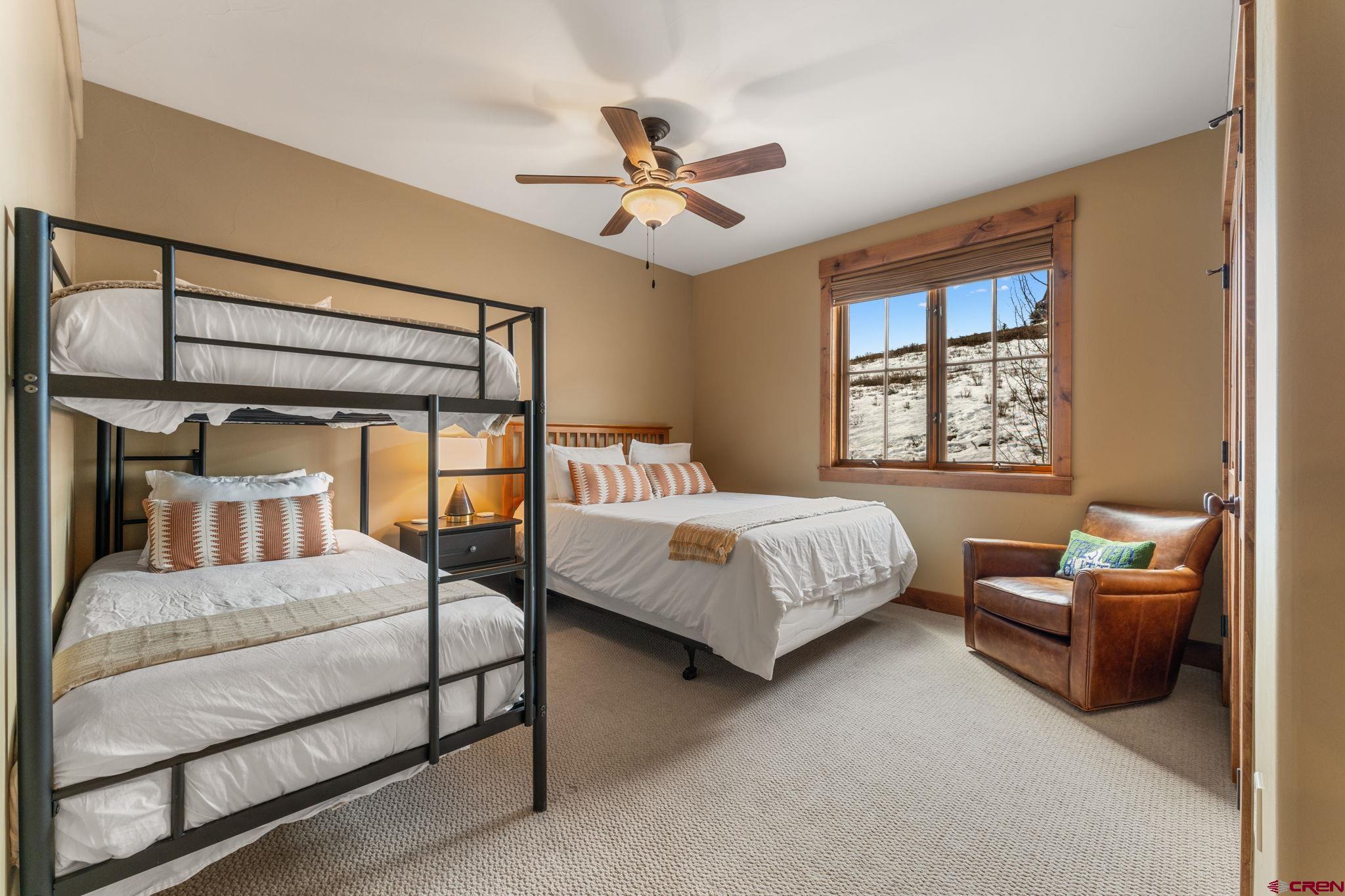 621 Gothic Road, Unit 2A Crested Butte, CO 81225 - Photo 21 of 34 a bedroom with a bed and a couch