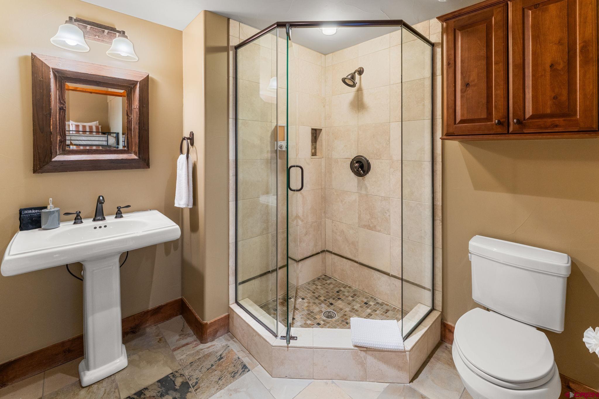 621 Gothic Road, Unit 2A Crested Butte, CO 81225 - Photo 23 of 34 a bathroom with a sink a toilet and shower