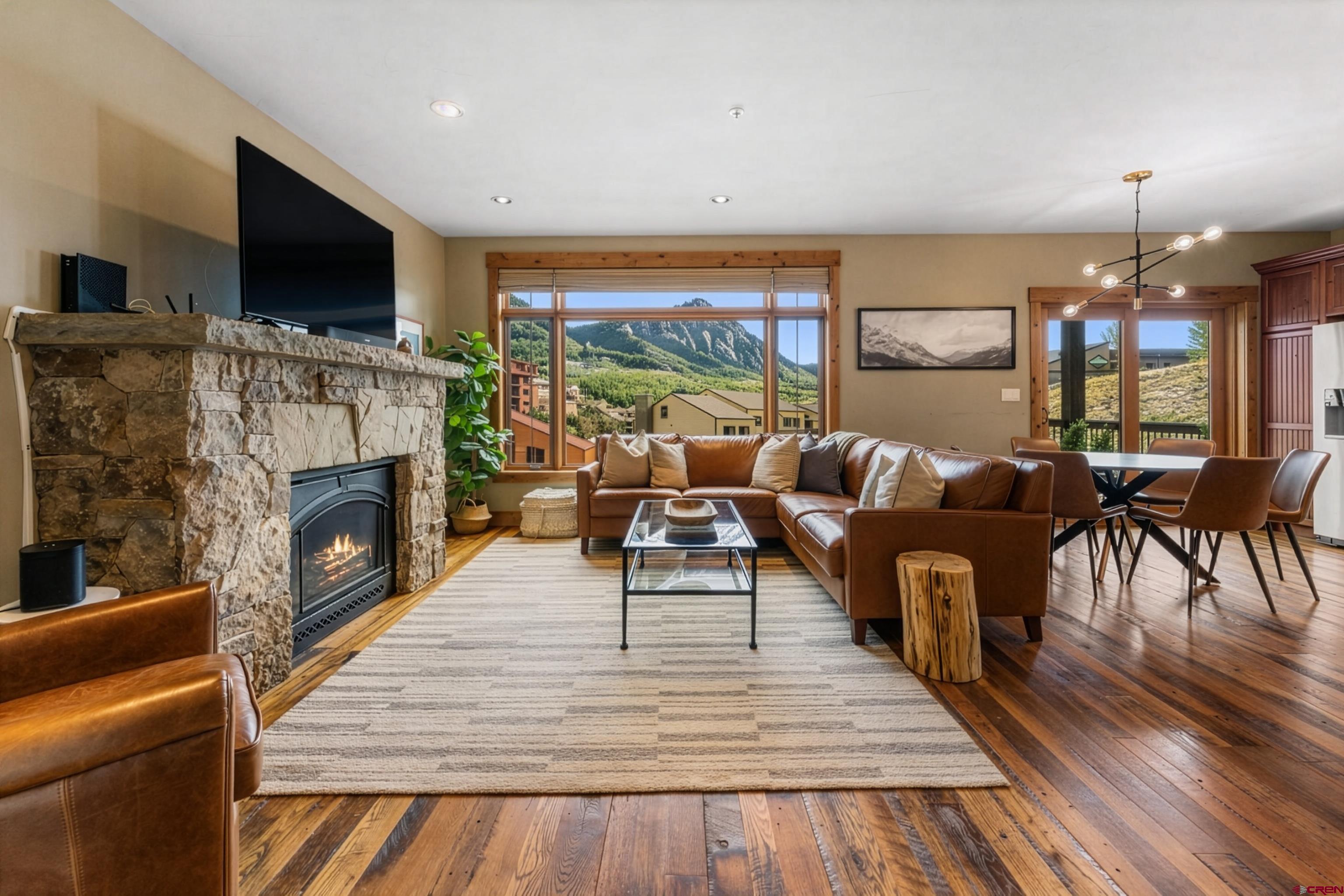 621 Gothic Road, Unit 2A Crested Butte, CO 81225 - Photo 4 of 34 a living room with furniture a flat screen tv and a fireplace