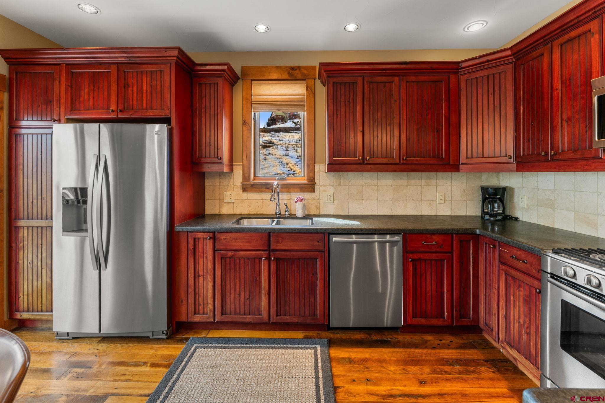 621 Gothic Road, Unit 2A Crested Butte, CO 81225 - Photo 10 of 34 a kitchen with stainless steel appliances granite countertop a refrigerator and a sink
