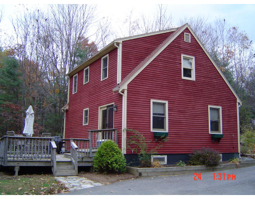 a front view of a house with yard and garage