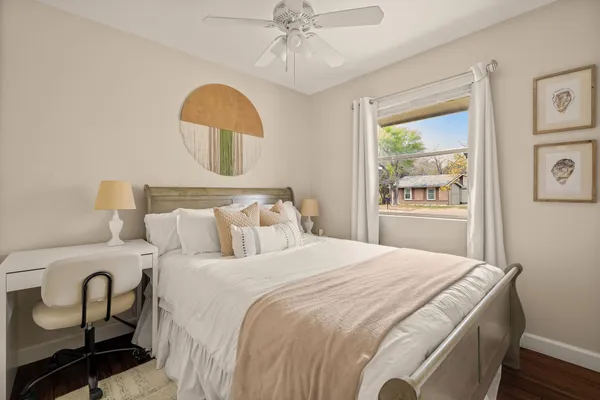 a bed room with a bed a television and a window