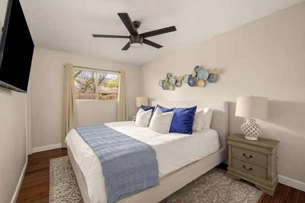 a bedroom with a bed and a flat screen tv