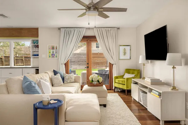 a living room with furniture and a flat screen tv